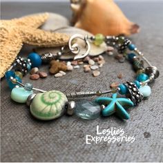 "◾One of a kind Artisan Bracelet. Made with an assortment of gemstones, art beads and hill tribe silver beads make this beach themed bracelet. Easy to put on swirl hook closure.  ◾Length: 7 1/2\" ◾Ceramic Raku Snail Bead by Keith O'Connor ◾Gemstones include: Agate, Aventurine, Blue Tourmaline, Blue Apatite, Green Garnet, Fluorite, Howlite, Crazy Lace Agate, Mint Blue Opal 🩴The Beachy Jewelry collection ... This collection celebrates the Ocean and Beach. Lots of Sea Life charms and colors. Very Ocean-inspired Turquoise Bracelets As Gift, Turquoise Ocean-inspired Bracelets As Gift, Turquoise Ocean-inspired Bracelets For Gift, Turquoise Starfish Beaded Bracelets, Ocean-inspired, Bohemian Starfish-shaped Turquoise Jewelry, Ocean-inspired Turquoise Starfish Beaded Bracelets, Bohemian Turquoise Starfish Jewelry, Handmade Turquoise Starfish Bracelets, Ocean-inspired Turquoise Beaded Bracelets For Gift