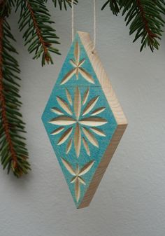 a wooden ornament hanging from a christmas tree