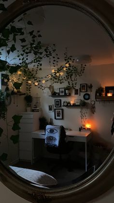 a mirror with plants and pictures on the wall