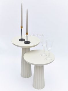 two white tables with candles on them