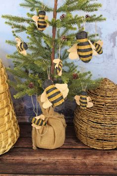 a small christmas tree decorated with bees and burlocks