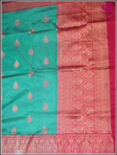 Adorn yourself in this Banarasi Katan silk saree in turquoise Blue with rigorously crafted zari woven floral motifs sprinkled over the fabric. The alluring blue body teams up with the pinkish red border and pallu. The zari woven floral pattern in pinkish red hue beautifully blends with the fabric, which results in grabbing attention with every move. The harmonious combination of blue and red is visually appealing, making this saree a perfect choice for those, who seeks elegance and vivacity for Turquoise Saree With Zari Work For Puja, Traditional Turquoise Wear With Zari Weaving, Festive Turquoise Silk Traditional Wear, Turquoise Pallu Saree, Turquoise Banarasi Silk Traditional Wear, Traditional Turquoise Saree With Zari Weaving, Turquoise Handloom Saree For Festivals, Turquoise Traditional Wear With Zari Weaving, Turquoise Saree With Cutdana For Puja