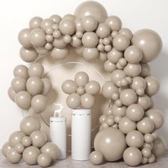 a bunch of balloons are arranged in the shape of a house and surrounding it,