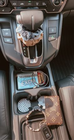 the interior of a car with various items in it's center console and steering wheel