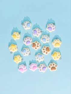 small plastic animal paw charms on a blue background