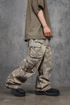 The Multi-Pocket Desert Cargo pants seamlessly blend street style with military aesthetics. Featuring an all-over camo print, these pants have a unique scimitar-like shape that creates natural creases, enhancing their edgy look. The multiple pocket design adds both functionality and a rugged appeal. Made from premium 100% cotton fabric, these pants ensure comfort and durability. The slightly oversized fit provides a relaxed, contemporary silhouette, making them an ideal choice for those who appr Cargo Pocket Design, Camo Pants Men, Techwear Fashion, Denim Pants Fashion, Street Style Outfits Men, Camo Designs, Guys Clothing Styles, Boys Wear, 90s Streetwear