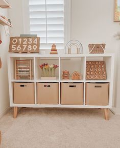 a white shelf filled with lots of storage bins