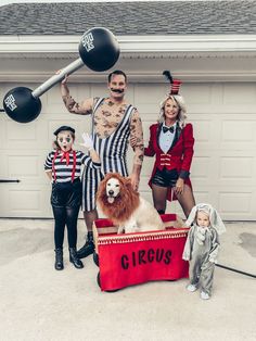 a group of people dressed up as circus performers and clowns in front of a garage