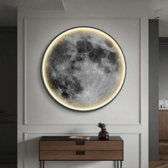 a room with a table and a large moon on the wall