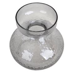 a clear glass vase sitting on top of a white table