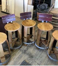 four wooden stools sitting next to each other on top of a hard wood floor