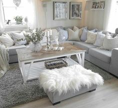 a living room filled with lots of furniture and white pillows on top of it's walls