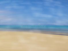 blurry photograph of the beach with blue sky and ocean in background royalty photo - illustration