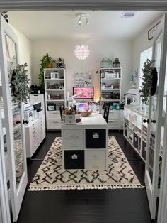 a room filled with lots of white furniture and shelves full of personal care items on top of a rug