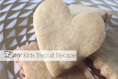 two heart shaped cookies are stacked on top of each other with the words easy kids biscuit recipe