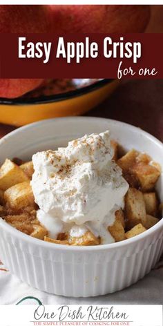 an apple crisp in a white bowl with whipped cream on top