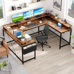 a computer desk with two monitors on it and a chair in front of the desk