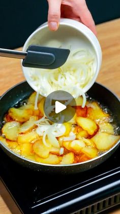 someone is adding noodles to a skillet on top of an electric stove with tongs