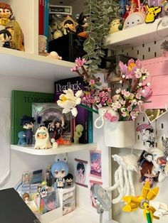 the shelves are filled with various items and flowers in vases on top of them