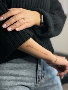 a woman with a small tattoo on her arm