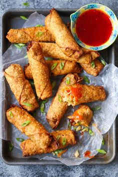 some fried food is on a tray with dipping sauce