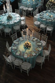 the tables are set with white and blue linens