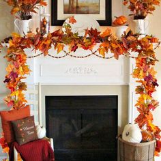 a fireplace decorated with fall leaves and pumpkins