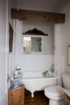 a bathroom with a toilet, tub and mirror