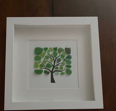 a white frame with a green tree cut out of it