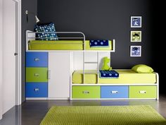 a bedroom with bunk beds and green rugs on the floor in front of black walls