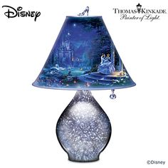 a lamp that is sitting on top of a table with a disney castle scene on it