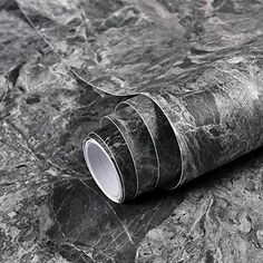 a roll of black marble paper sitting on top of a table