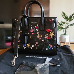 Brand New!! Calfsin Crystal Embellished Nano Sac De Jour. Details Height: 7 In Weight: 21.5 Oz Drop: 18.5 Width: 4 In Base Lenght: 8.75 In Drop: 3 In Comes With Dustbag Strap Clochette Lock Key Designer: Ysl Full Set Next Day Shipping Ysl Monogram Chain Wallet, Ysl Toy Loulou, Mini Hand Bag, Yves Saint Laurent Bags, Mini Hands, Heart Bag, Monogrammed Leather, Mini Heart, Saint Laurent Bag