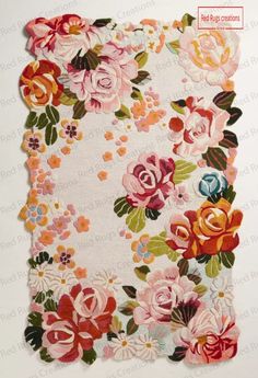 a piece of fabric with flowers and leaves on the front, in pinks and oranges