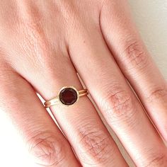 Garnet ring. Round Garnet in rub over setting. Bezel set simple elegant Garnet ring that can be a match to any occasion. Garnet measures 9mms and weighs 1.7 carats The ring is in 10 carat yellow gold The ring size is M (Australian size) or 6 (US size). The ring is ready to ship in 1-2 working days.  We resize free of charge.  Please allow a couple of additional days for resizing. All my rings come in a velvet ring box.  I am highly conscious of environmental damage that extra packaging can creat Ruby Ring In Yellow Gold With Bezel Setting, Yellow Gold Ruby Ring With Bezel Setting, Gold Ruby Ring With Tension Setting For Formal Occasions, Classic Red Rings With Bezel Setting, Gold Rings With Smooth Bezel And Round Stone, Yellow Gold Stackable Rings Smooth Bezel As Gift, Classic Red Ring With Bezel Setting, Gold Birthstone Ring With Smooth Bezel For Promise, Classic Red Bezel Set Ring