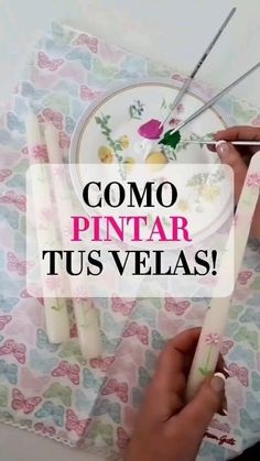 a woman is painting flowers on a plate with paintbrushes in front of her and the words como pintar tus velas