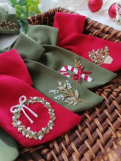 some red and green napkins sitting in a wicker basket next to christmas decorations