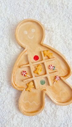 a cookie shaped like a person with candy on it