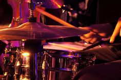 a person playing drums in front of a drum set