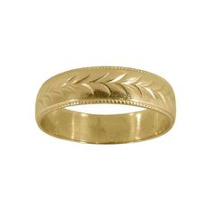 a gold wedding ring with leaves on it