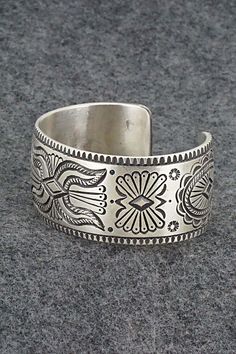 This exceptionally crafted sterling silver bracelet was made by Navajo silversmith Calvin Martinez. The inside is signed C MTZ, Navajo and stamped sterling.Size: 5 3/8" (will fit up to a 6 3/8" wrist)Gap: 1"Width: 1 1/16"Free shipping on all orders! We ship with USPS and always include tracking. All orders ship within a day of payment.Returns are accepted up to 30 days after you receive your order. Just send us a message. Our shop offers cash back or store credit. The item must be returned in ne Bohemian Antique Silver Sterling Silver Bracelet, Handcrafted Silver Bracelets As Gift, Hand Tooled Silver Bracelet As A Gift, Hand Tooled Silver Bracelets As A Gift, Silver Hand Tooled Bracelet For Gift, Bohemian Antique Sterling Silver Bracelet, Hand Tooled Silver Bracelet For Gift, Bohemian Etched Sterling Silver Bracelets, Bohemian Sterling Silver Engraved Bracelet