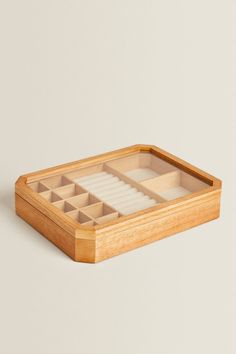 an empty wooden box with compartments on it