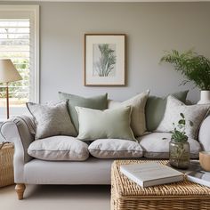 a living room filled with lots of furniture and pillows on top of a white couch