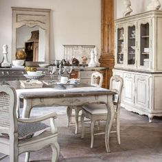 a dining room table and chairs in front of a tall clock