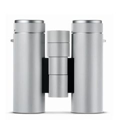 two silver binoculars sitting next to each other on top of a white surface with black trim