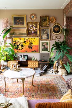 a living room filled with lots of plants and pictures