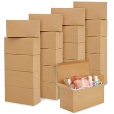 several cardboard boxes are stacked on top of each other and one is open to reveal the contents