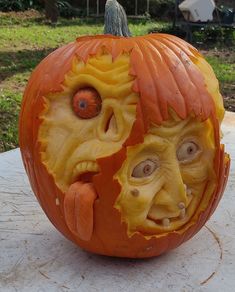 a carved pumpkin with an evil face on it