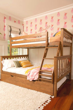 a wooden bunk bed sitting on top of a hard wood floor next to a white rug