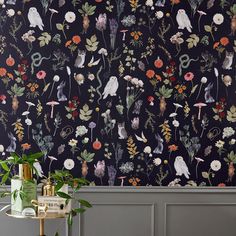 the wallpaper in this room is very colorful and has flowers, birds and plants on it